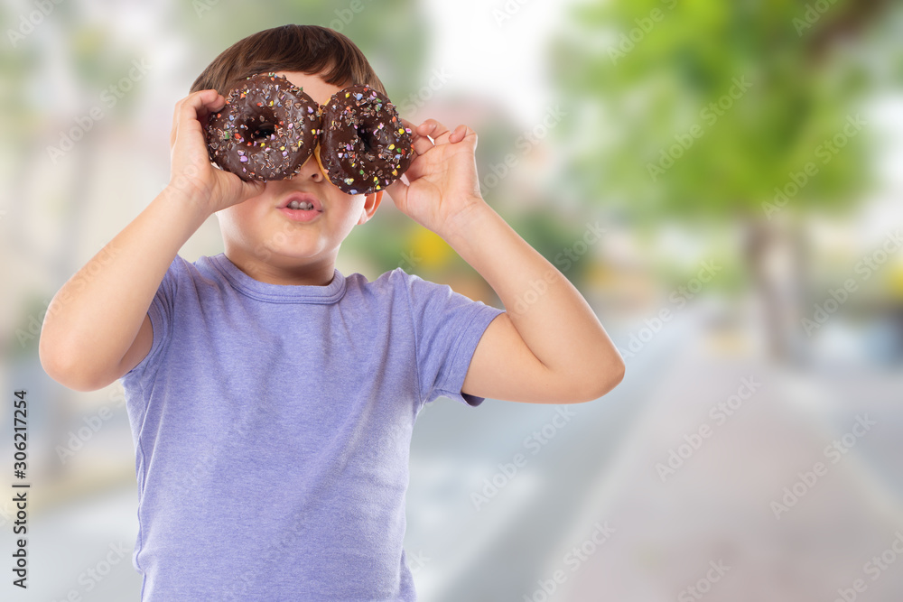 Little boy child with donuts donut having fun happy happiness town unhealthy eating Little boy child with donuts donut having fun happy happiness town unhealthy eating