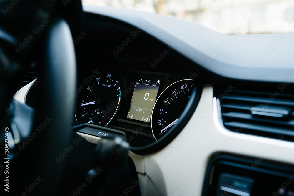 Interior view of modern luxury car with analog and digital speed limit clock and zero kilometers on the digital dot matrix screen
