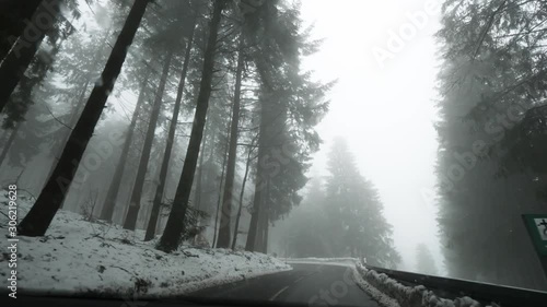 Driving POV personal perspective of covered with snow road in German Black Forest mountains safety driving after snow tempest 4k UHD footage photo