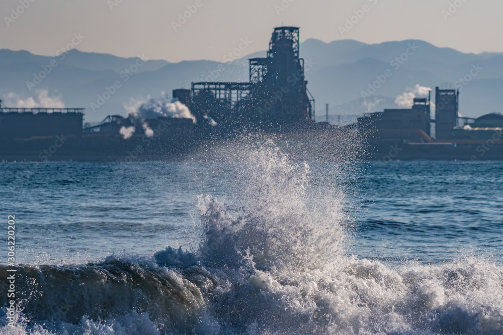 Wild sea with industrial background, steel factory complex at seaside of Pohang, South Korea