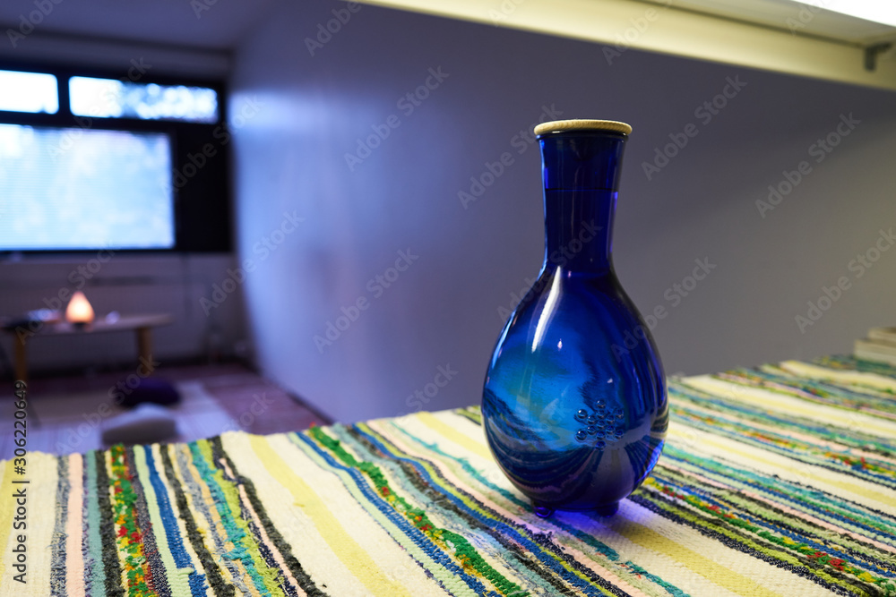 round blue water jar in studio.