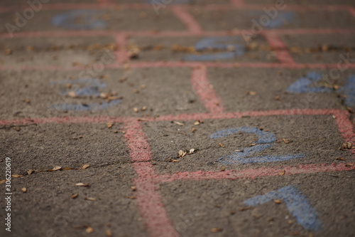 Children s hopscotch game painted on asphalt road.