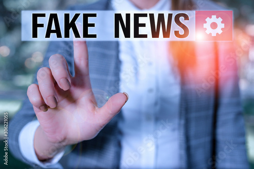 Text sign showing Fake News. Business photo showcasing Giving information to showing that is not true by the media Business woman in the nature pointing with the finger into empty space photo