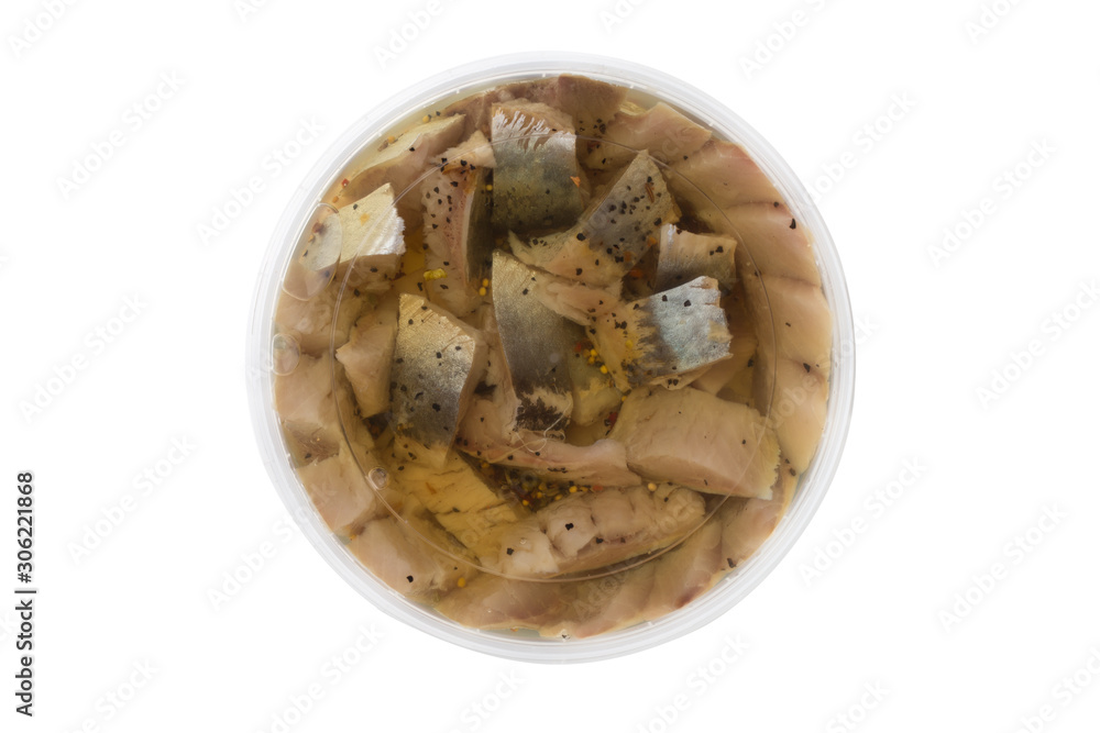 Marinated fish in a plastic container. Pieces of pickled herring in the package from the store on a white background. Marinated fish in a plastic container. Pieces of pickled herring in the package from the store on a white background.