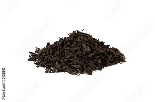 Black tea on a white background. A pile of dried tea leaves on a white background.