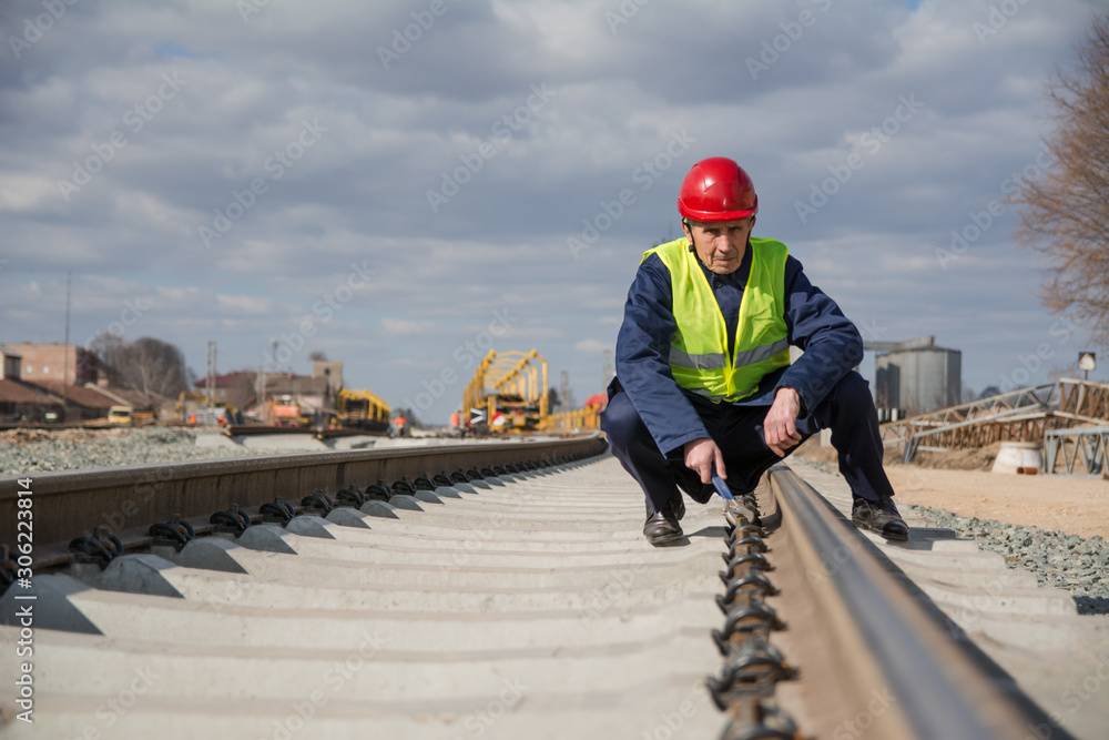 Railway worker working on railway track Railway worker working on railway track