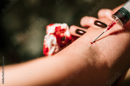 Close-up of injecting heroin with syringe, drug addiction. Substance abuse