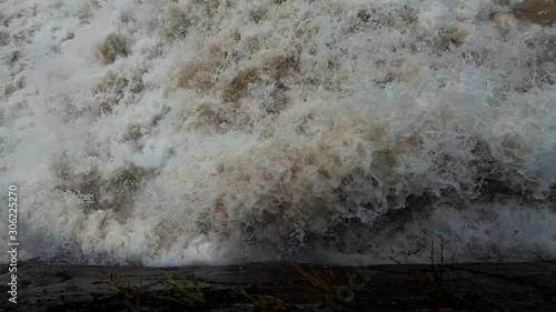 Slow motion looking down on flooded rapid river water