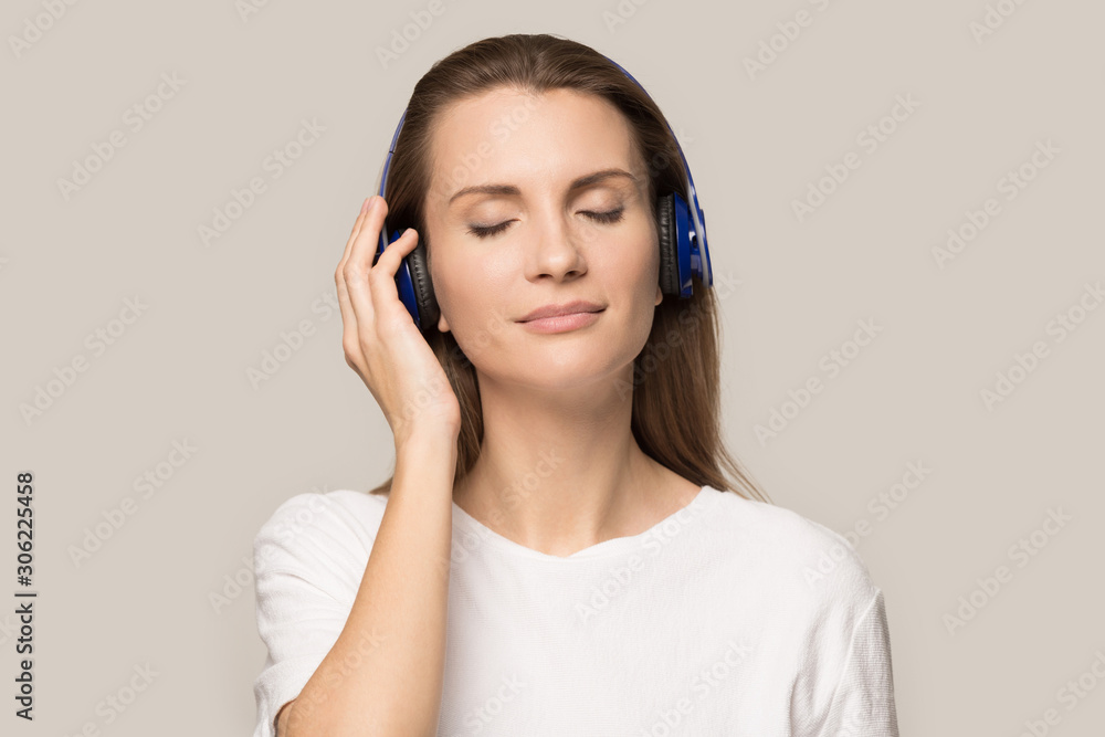 Happy satisfied woman in headphones enjoying favorite music Happy satisfied woman in headphones enjoying favorite music