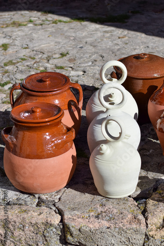 Earthenware pitchers and pots in a market in Spain.