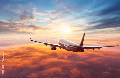 Obraz na plátně Passengers commercial airplane flying above clouds
