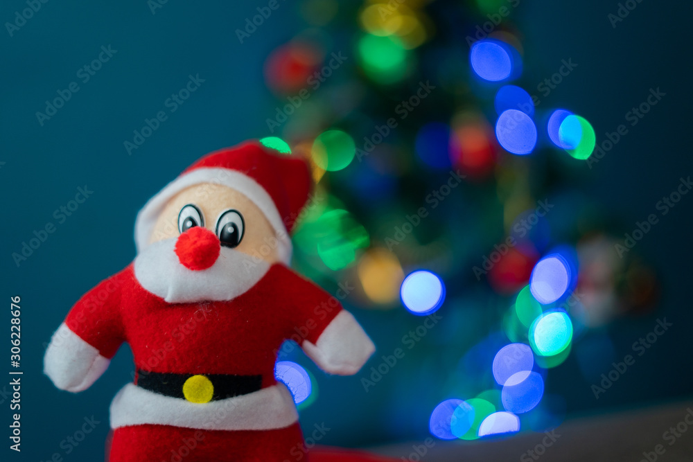 Santa Cluas composition on the green wall background Beautiful decoration and elegant accessories. Merry Christmas and Happy Holidays, lighting on Christmas tree Santa Cluas composition on the green wall background Beautiful decoration and elegant accessories. Merry Christmas and Happy Holidays, lighting on Christmas tree