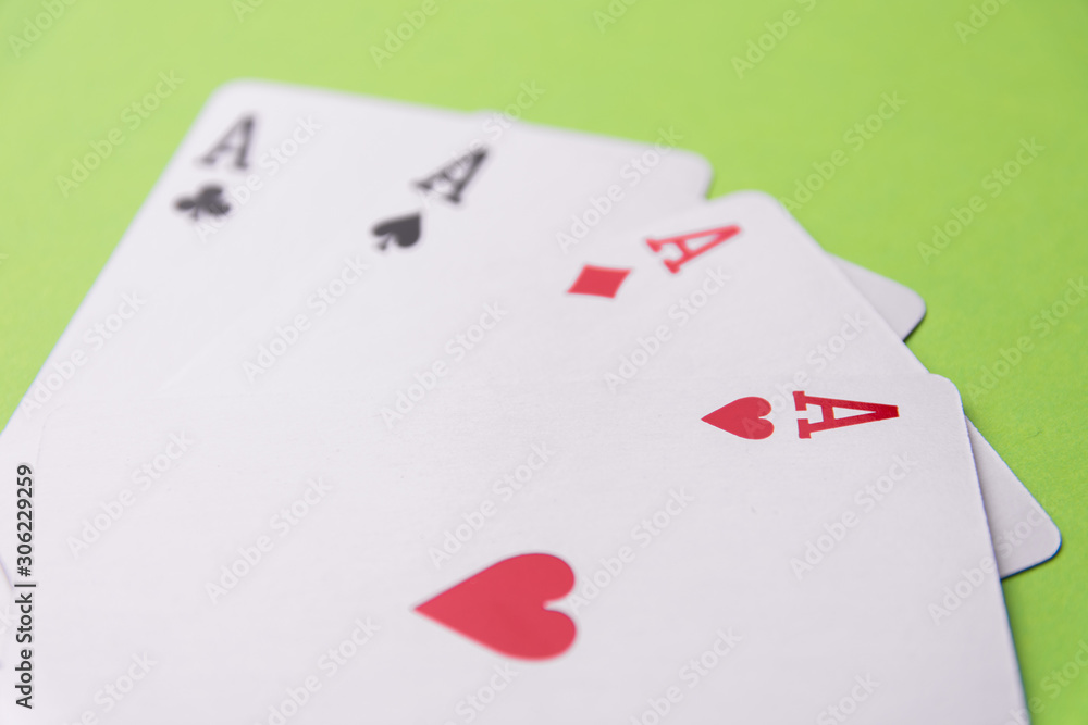 Four aces on green background. Concept of gambling risk. From above. Copy space