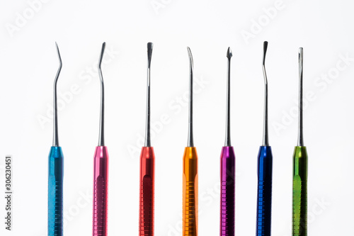 set of bright surgical metal raspors on a white background photo