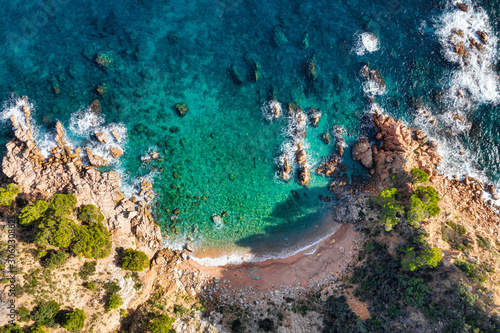 Sea Aerial view. Top view, nature background. Azure sea beach with rocky mountains and clear water at sunny day. Flying drone. Tropical trees.