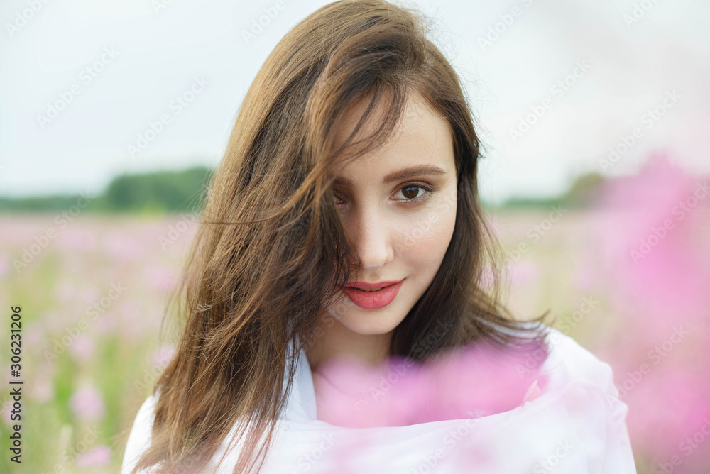 Beautiful girl in a field of lilac flowers. Beautiful girl in a field of lilac flowers.