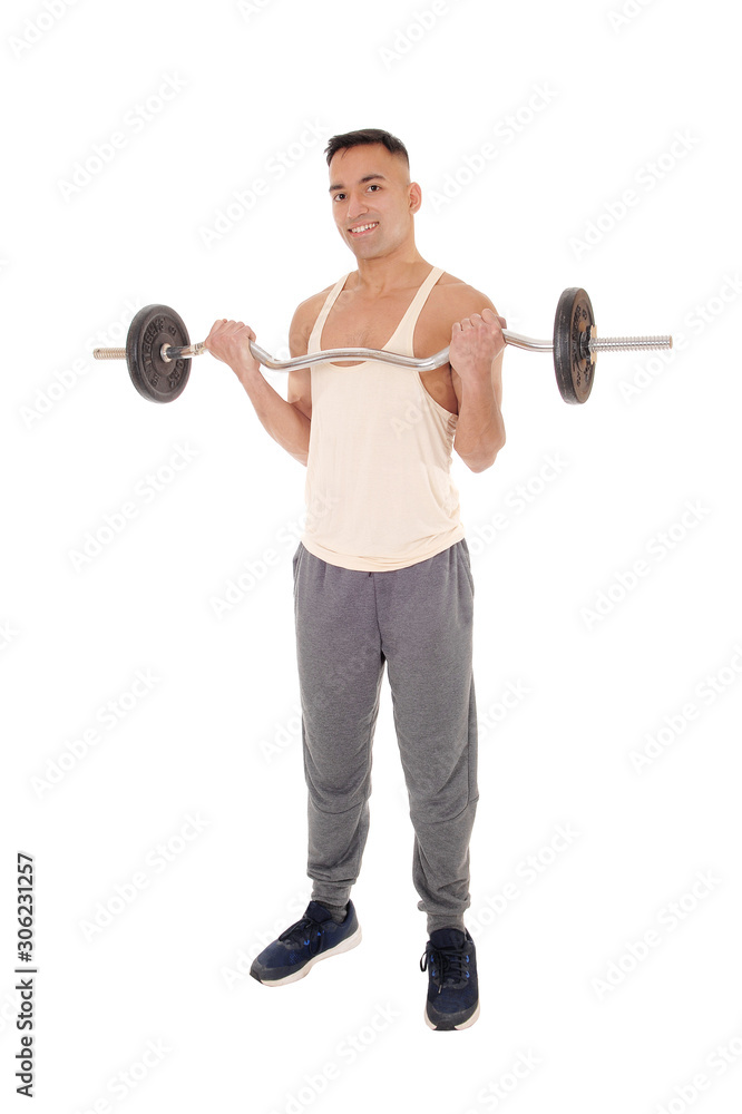 Young east Indian man standing weigh lifting Young east Indian man standing weigh lifting