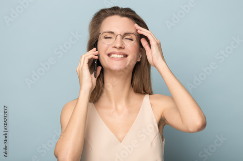 Smiling happy woman talking on phone, hearing good news