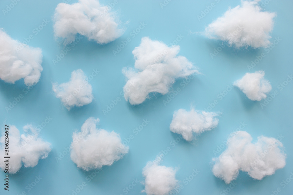 Cotton wool clouds on light blue background. Stock Photo Adobe Stock