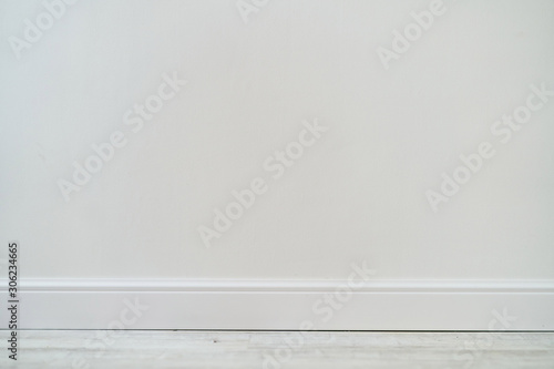 Empty room with white cement wall texture and white wooden floor pattern. 