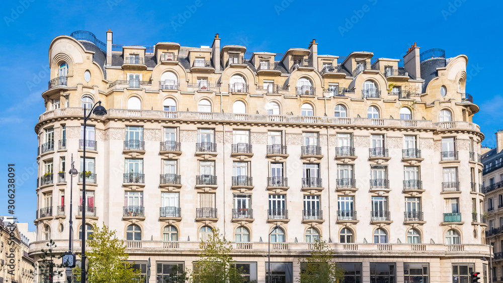 Paris, parisian facade in a chic area, typical balcony and windows boulevard Haussmann