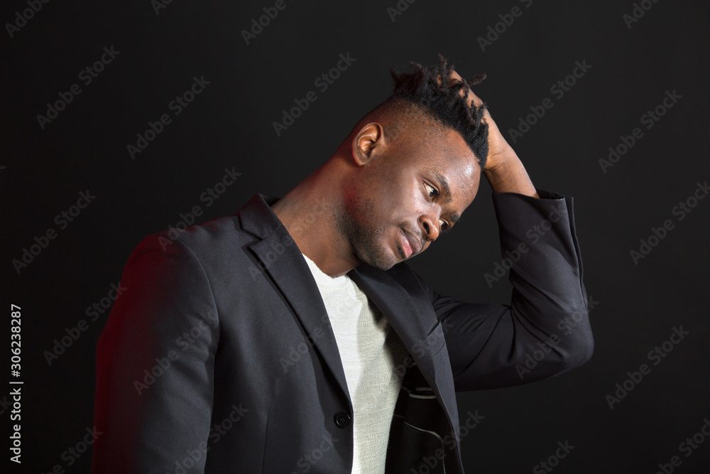 handsome african man in suit on black background