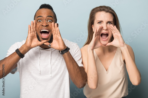 Excited emotional African American man and woman shouting