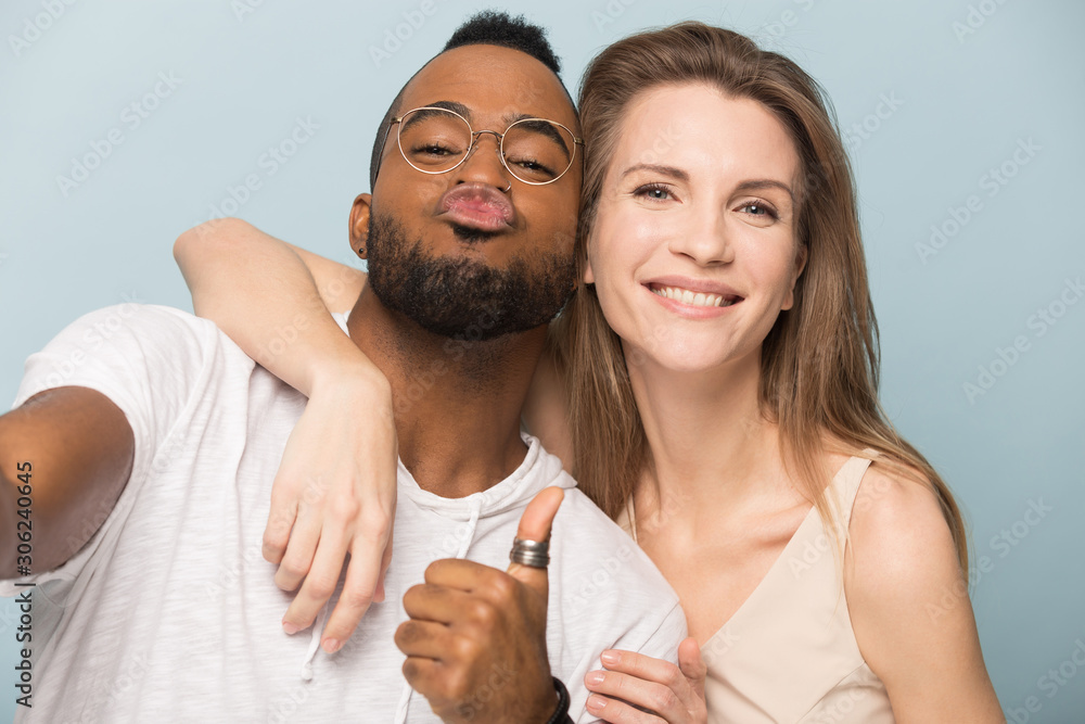 Φωτογραφία Funny African American man and Caucasian woman taking selfie together