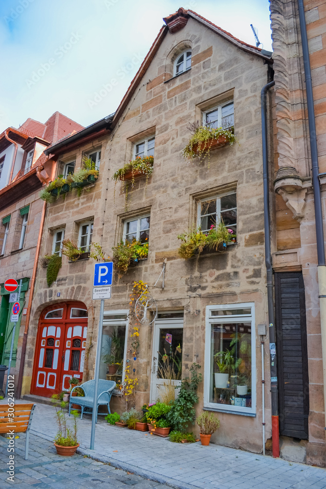 Fototapeta premium Furth, Germany, 21 November 2019: view of one of the city streets. 19th century houses with multi-colored facades. Bicycle parking. Garbage bins.