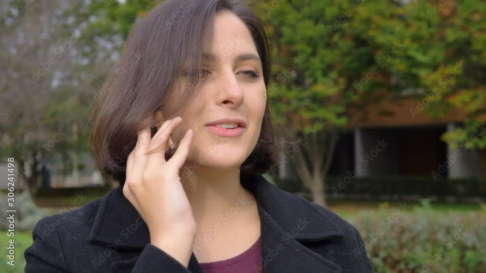 confident attractive young business woman talking by phone smiling in the park confident attractive young business woman talking by phone smiling in the park