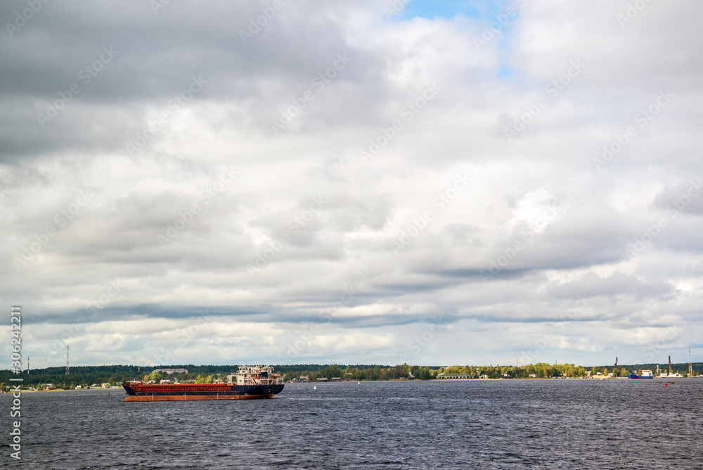 Barges with cargo swimming along the banks of the north-west river