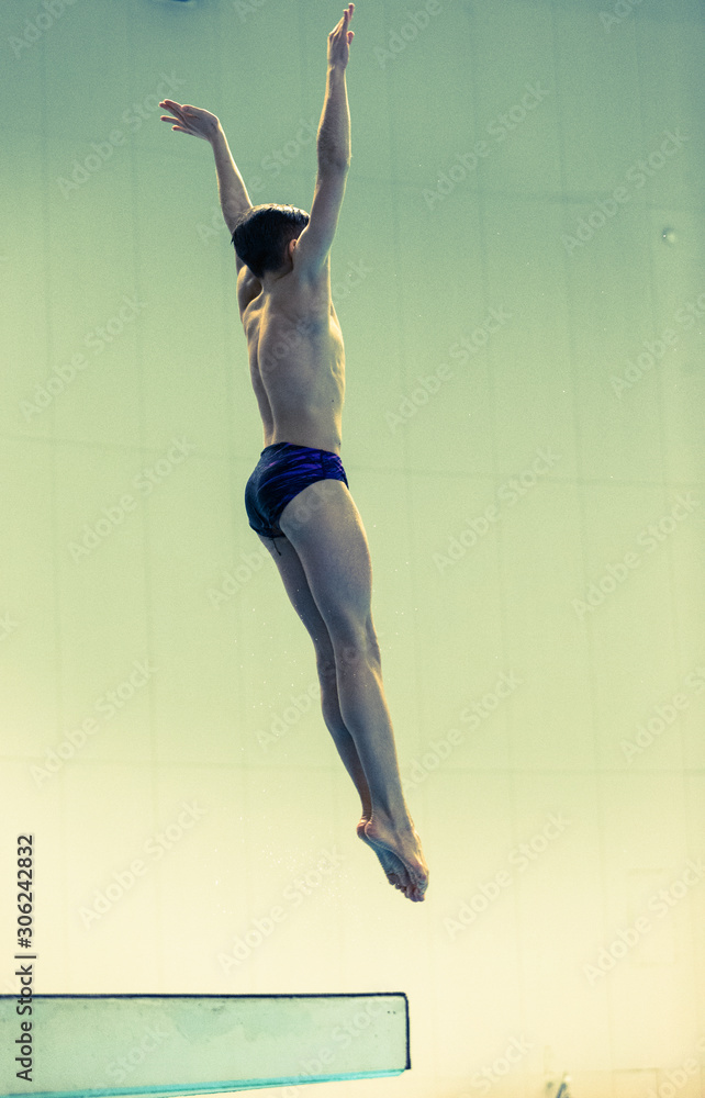 Platform diver performing a reverse dive piked Stock Photo | Adobe Stock