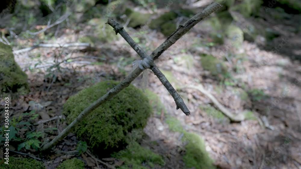 small cross of woods in forest ground, dolly in close up shot small cross of woods in forest ground, dolly in close up shot