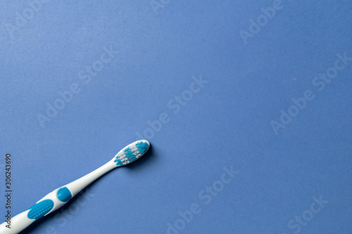 blue and White toothbrush on blue background top view