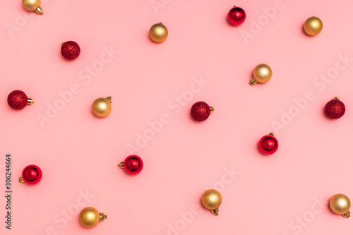 Christmas composition. Pattern of christmas red and gold balls on pink background. Trendy colors of christmas 2020. Flat lay, top view