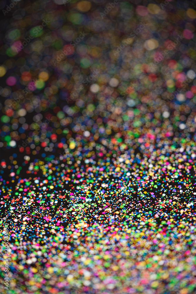 Beautiful Christmas light background. Abstract glitter bokeh and scattered sparkles in gold, on black Beautiful Christmas light background. Abstract glitter bokeh and scattered sparkles in gold, on black