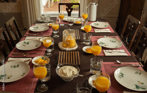 Brunch party dinning table with orange juice