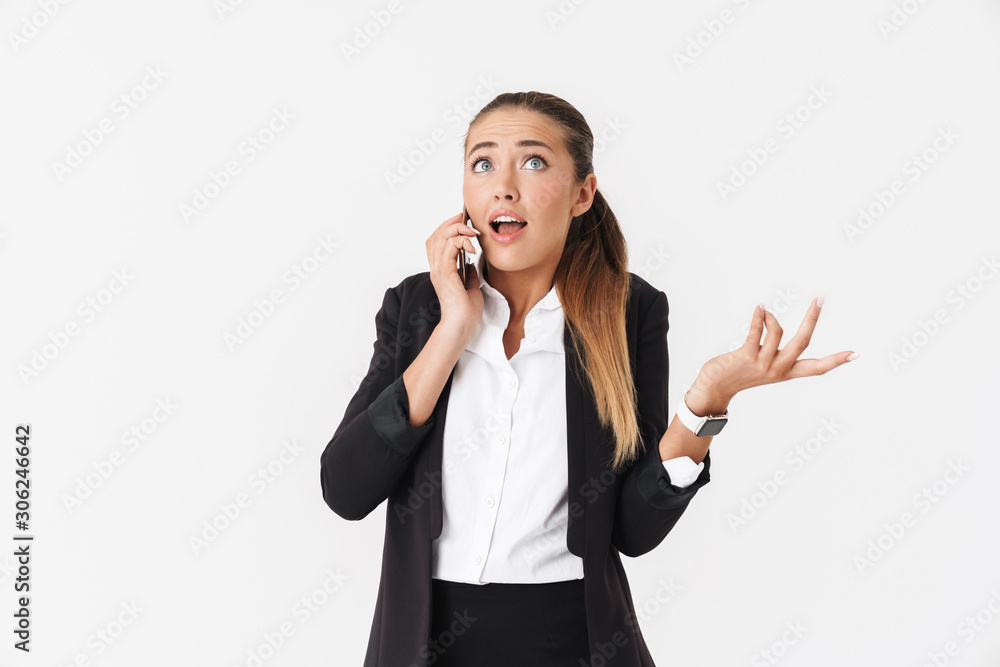 Photo of businesswoman looking upward and talking on cellphone Photo of businesswoman looking upward and talking on cellphone