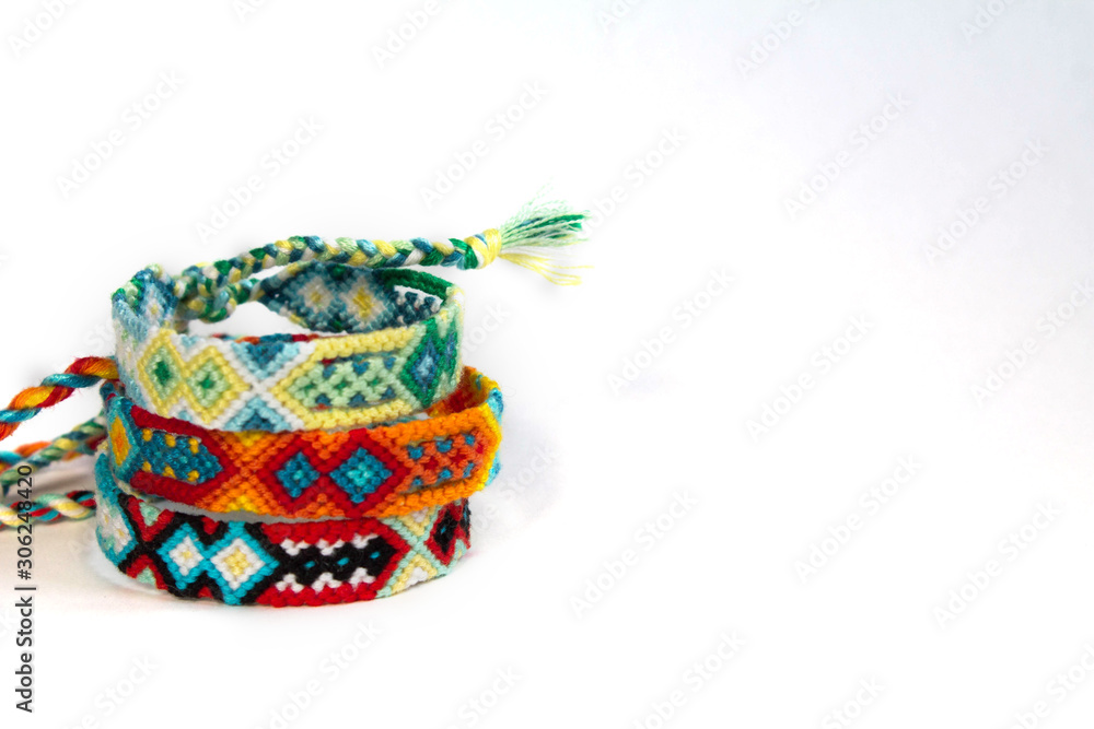 handmade friendship bracelets on white background, ethno boho style