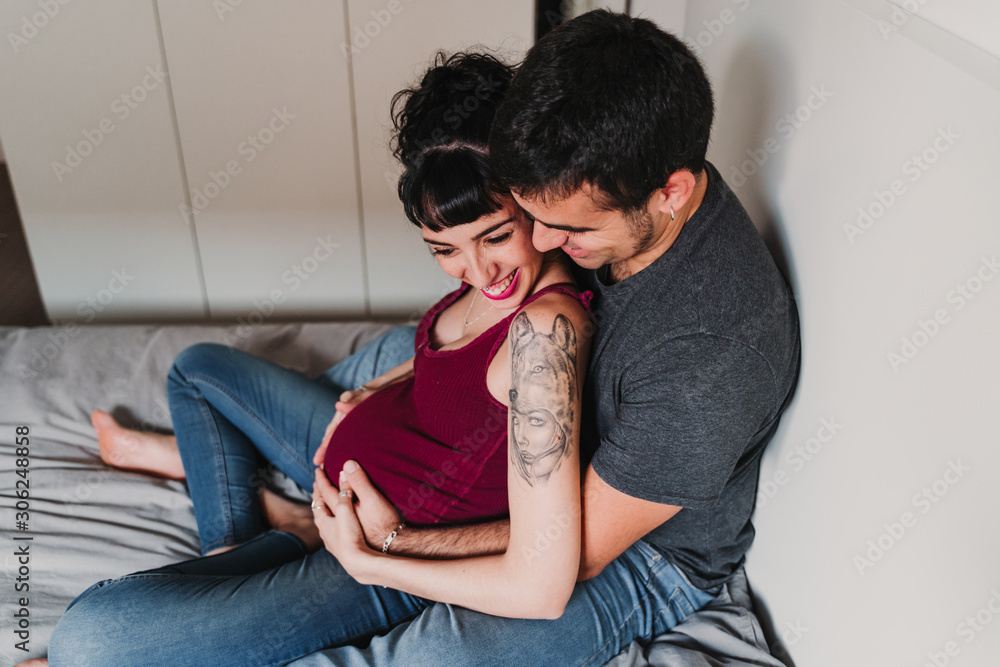 young couple at home hugging. Happy Pregnant woman smiling young couple at home hugging. Happy Pregnant woman smiling