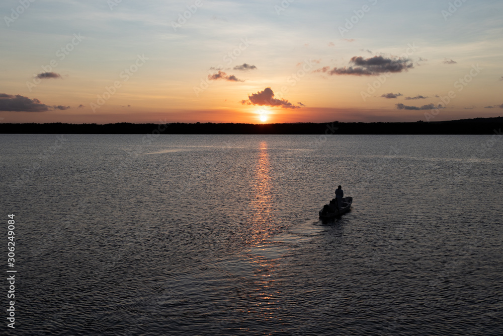 Silhouette of boat on the river at sunset