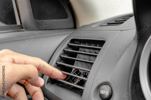 reaching broken plastic air director by finger in air conditioner (AC) outlet inside a car