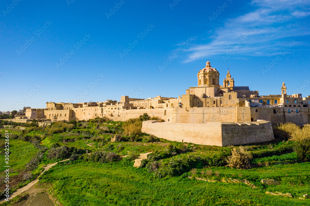 Mdina city - old capital of Malta. Aerial nature landscape, sunny day, blue sly, winter, a lot of green grass. Europe. Malta