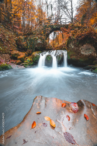 The Schiessentumpel waterfall cascade in Luxembourg Mullerthal trail druring autumn fall in November longexposure photo