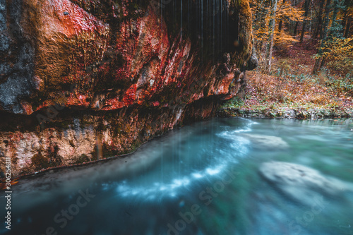 Kallektuffquell waterfall on Mullerthal trail in Luxembourg longexposure crystal clear water autumn fall in November
