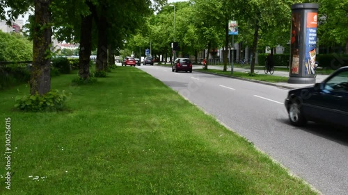Timelapse of city traffic in a crossroad in Munich Germany. Lots of cars, ciclysts and pedestrians are in a traffic light. photo