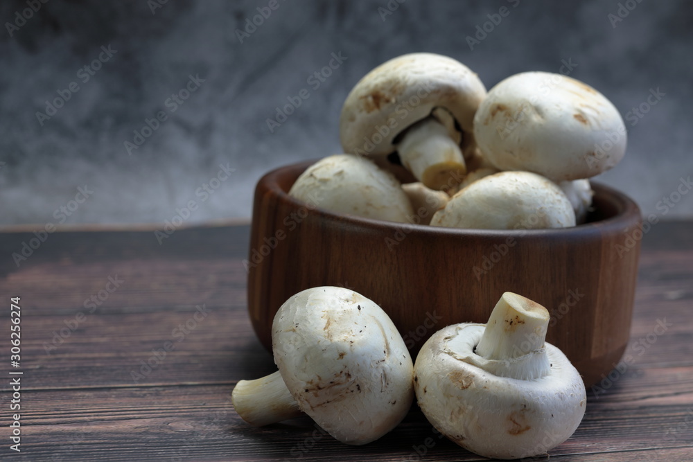 Button Mushrooms in a wooden bowl Button Mushrooms in a wooden bowl