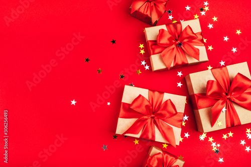 Several gift boxes with bows on a red background.