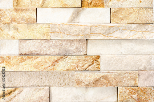 Close-up of Natural River Stone Cladding Mosaic Tile Wall .Old stone facade, seamless pattern .