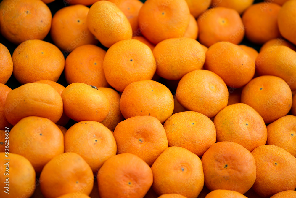 Tangerines in a grocery store. Texture photo of juicy mandarin orange in a market stall